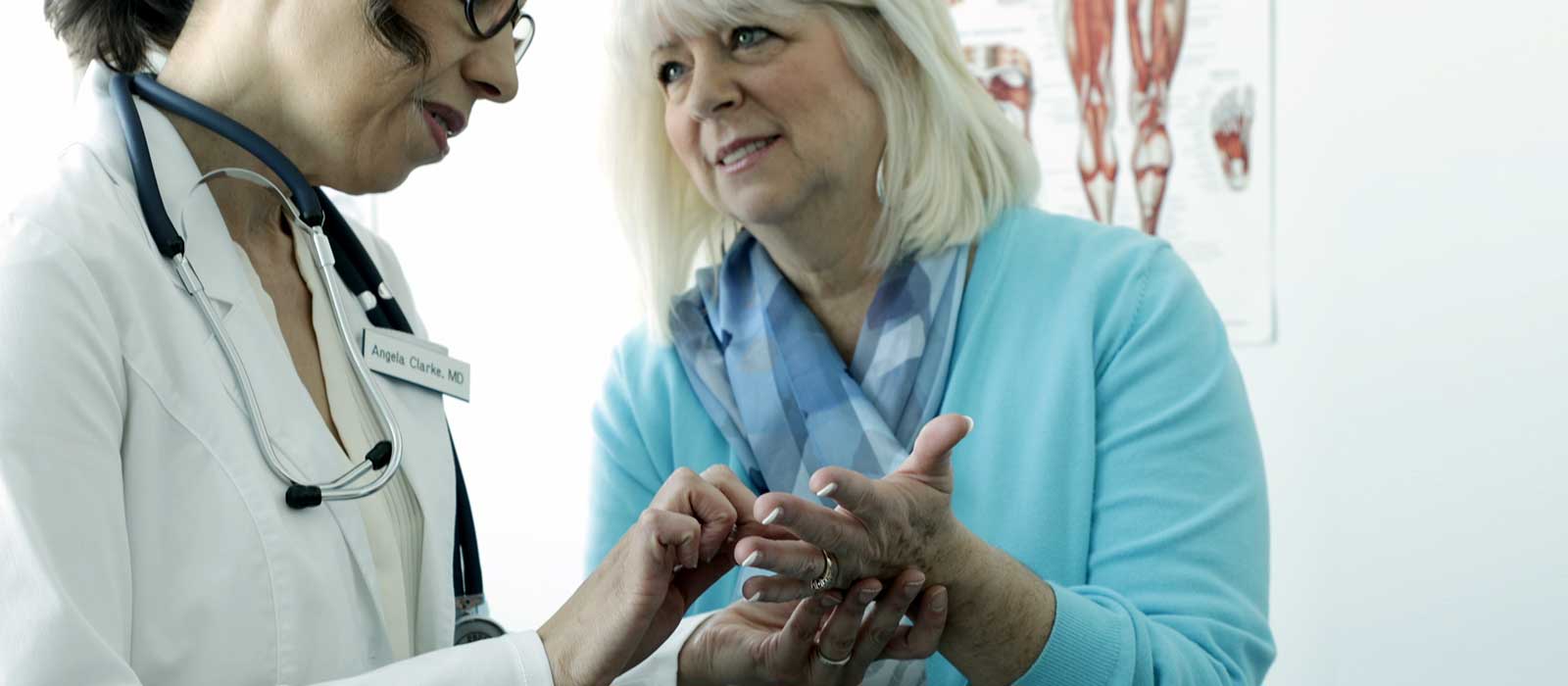 Specialists examining patient's hand