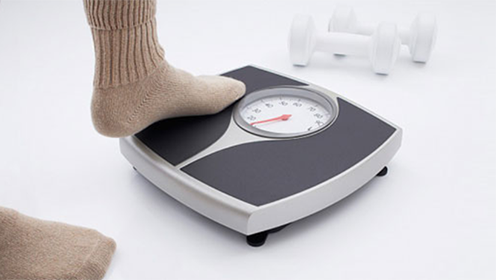 a person's foot stepping onto a scale