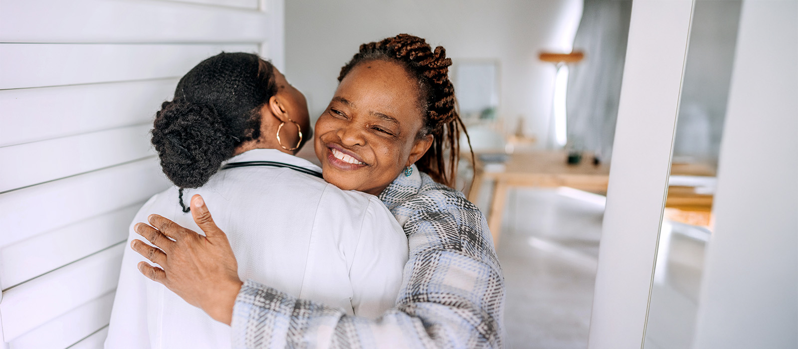 Diverse female hugging healthcare worker