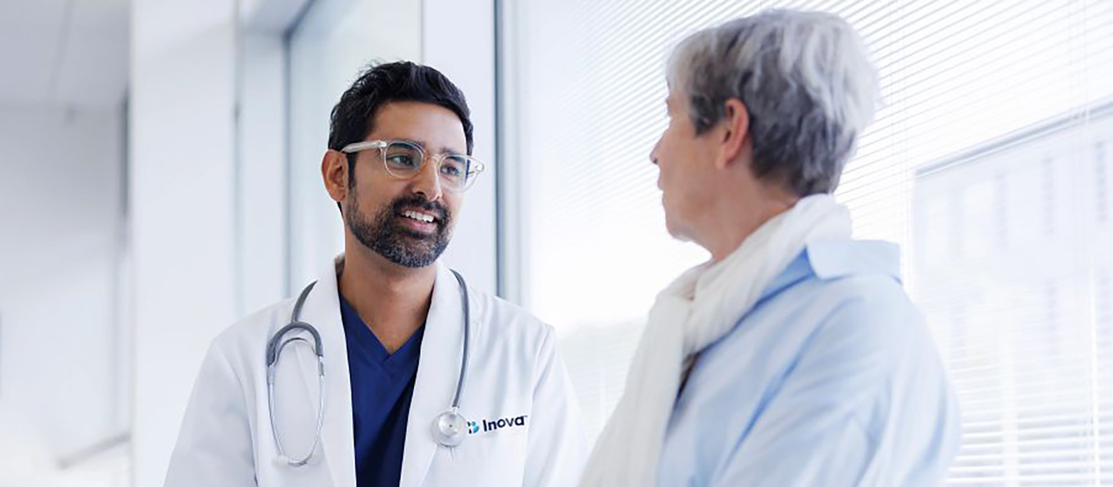 woman speaking with male doctor