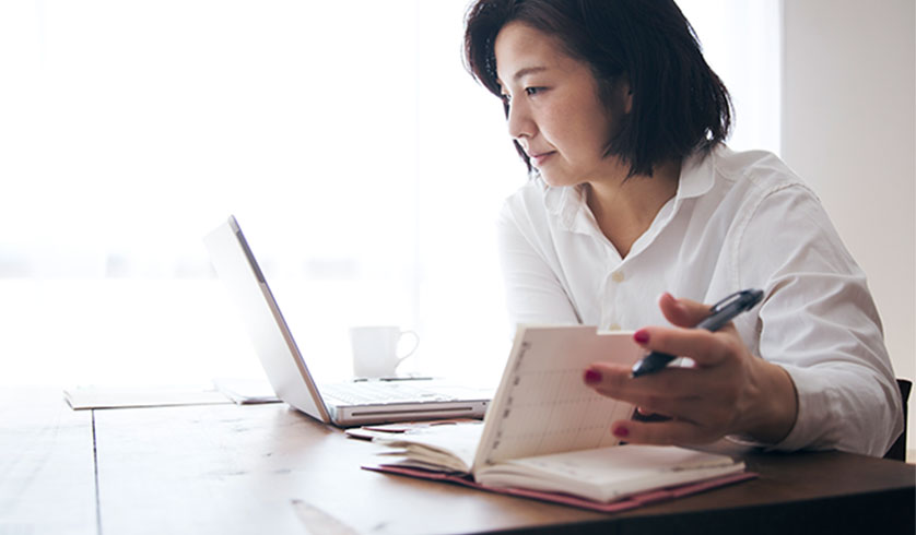 Middle aged woman viewing laptop