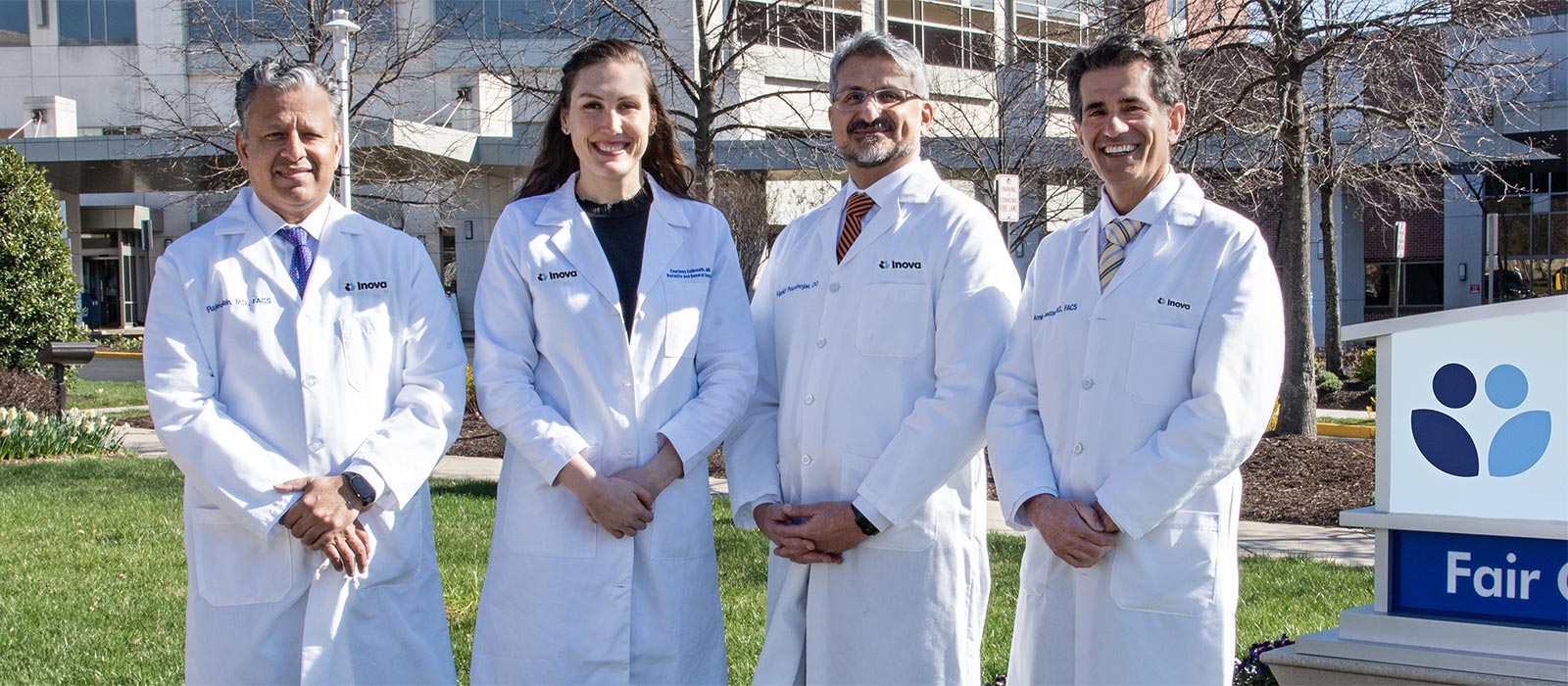 four doctors in front of hospital