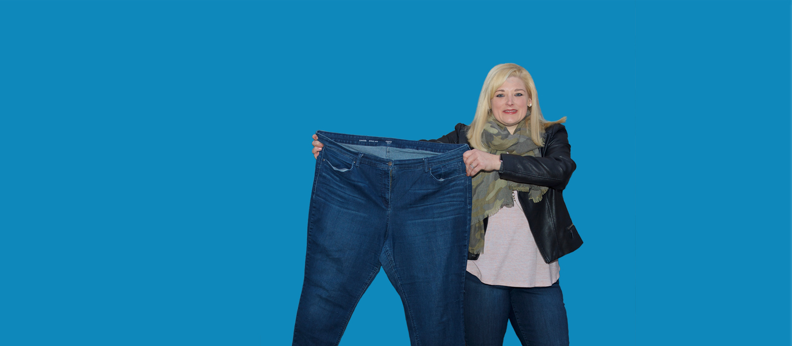 Female patient holding up jeans
