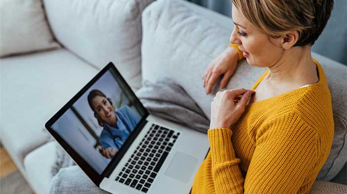 Woman at home video conference on her laptop.