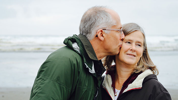 Mature couple walking on beach