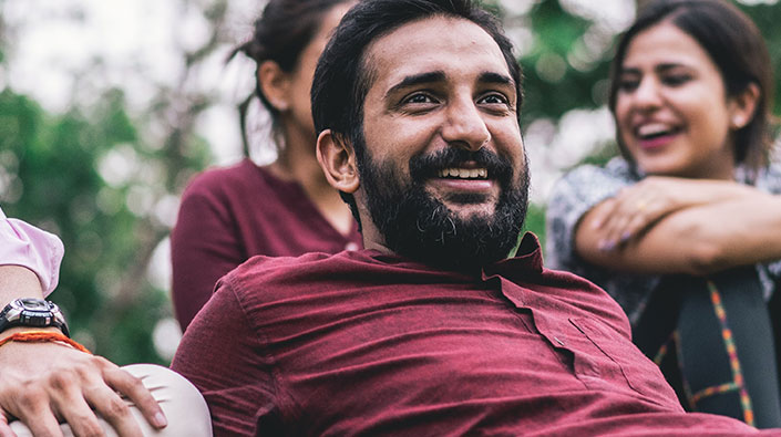 Smiling man with friends outdoors