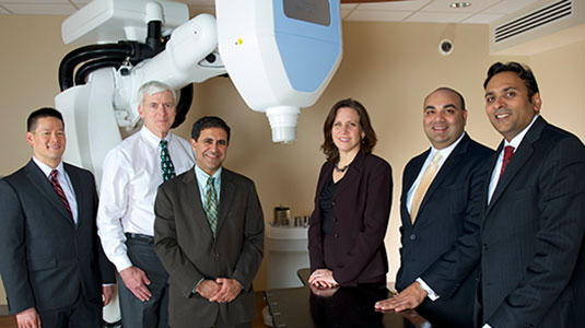 doctors with CyberKnife machine