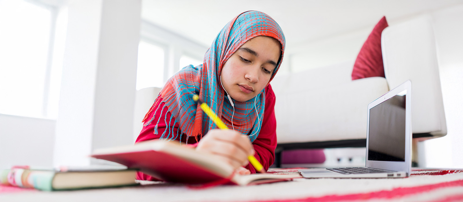 young girl studying on floor