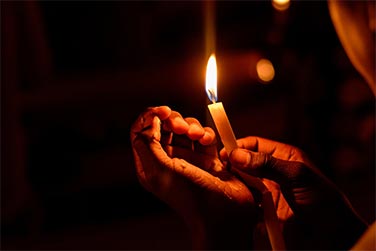 closeup of hands holding a candle
