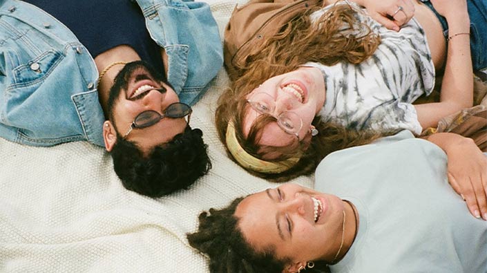 three friends looking up at the sky