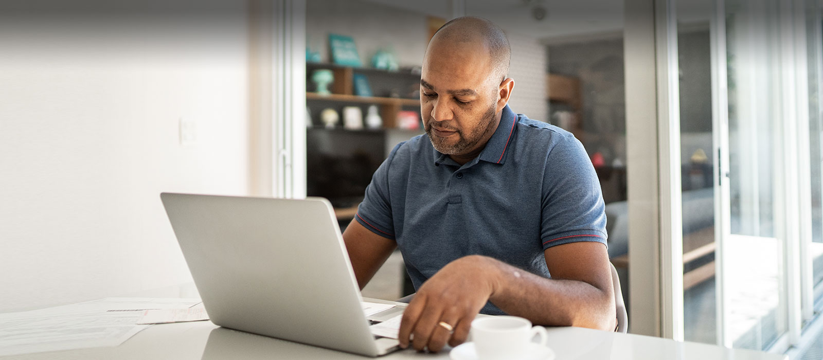 Middle aged diverse man using laptop 