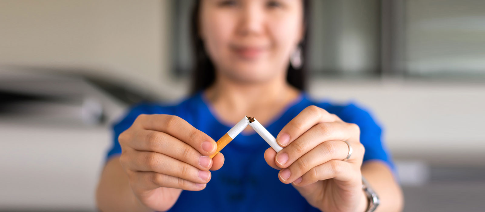 Woman breaking a cigarette 