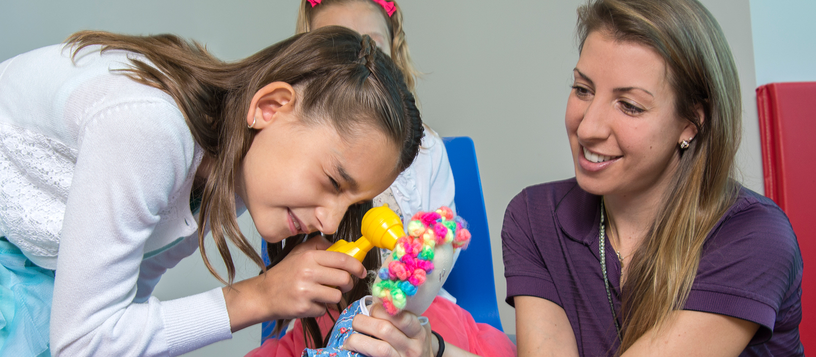 child learns sibling care with adult