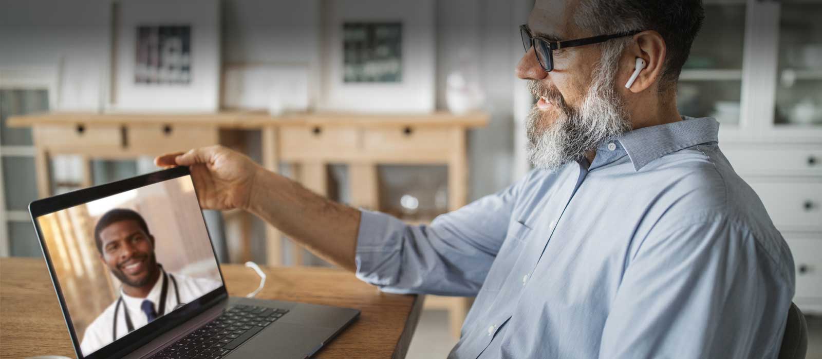 Mature man using telemedicine app with specialist