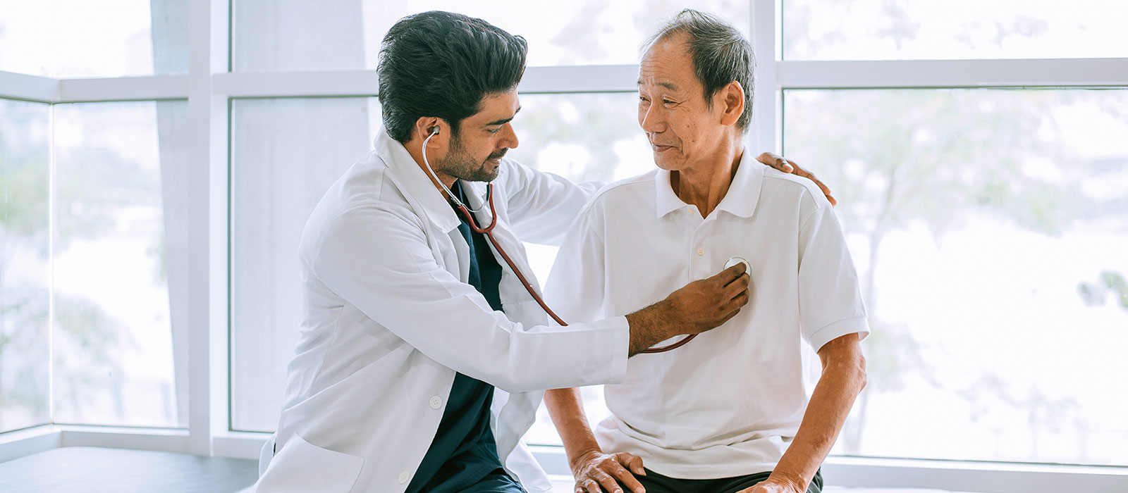 A male doctor checking a patient's heart health