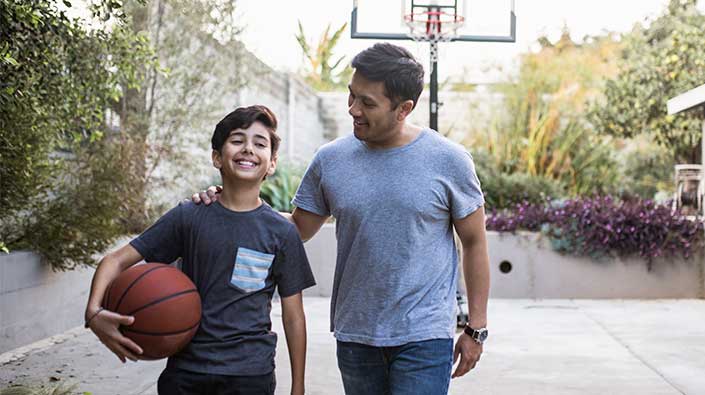 Father and son playing basketball