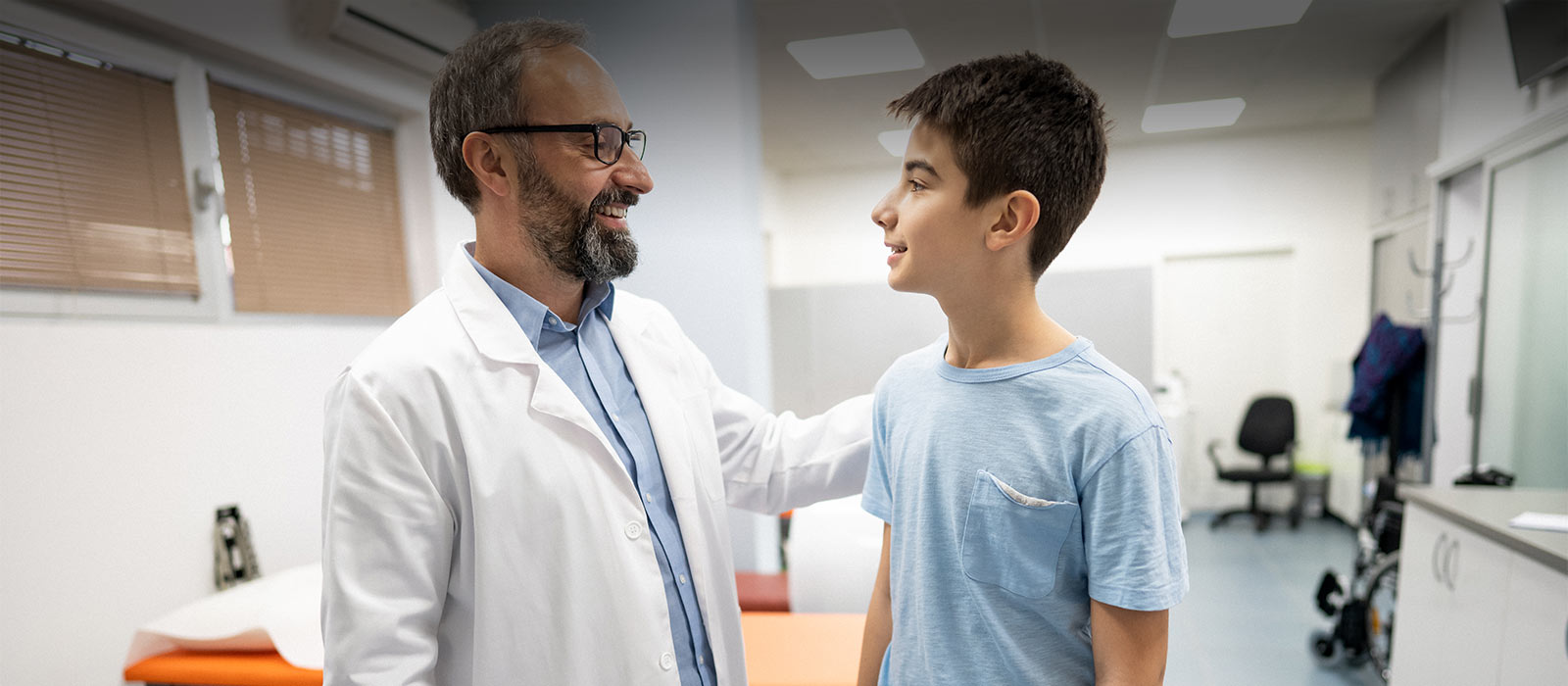 Doctor greeting teenage boy
