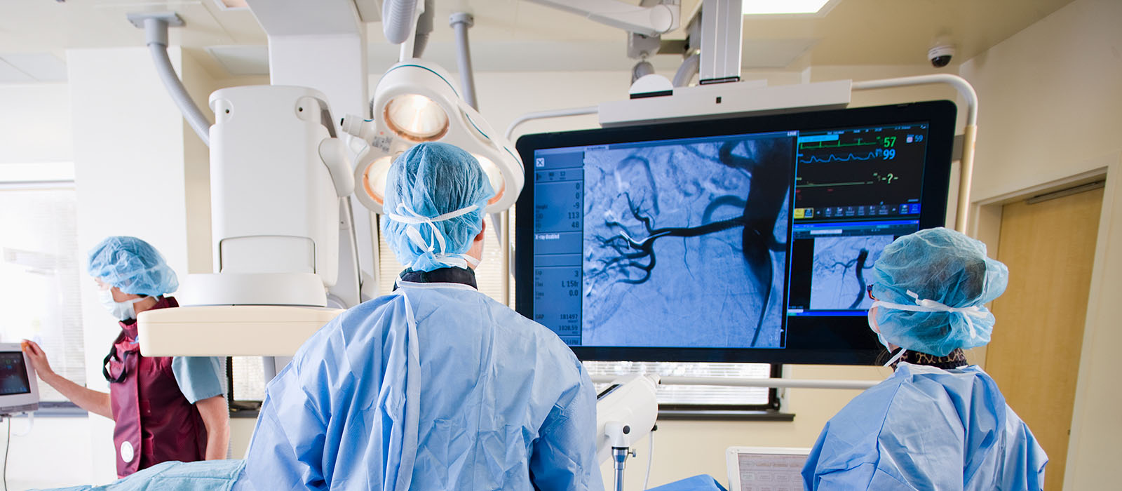 Surgical team viewing monitors