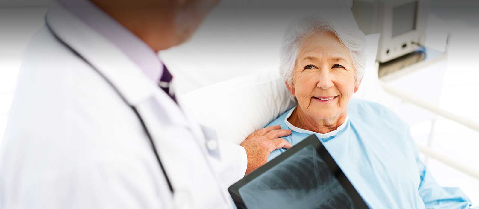 Mature female patient reviewing scan with doctor.
