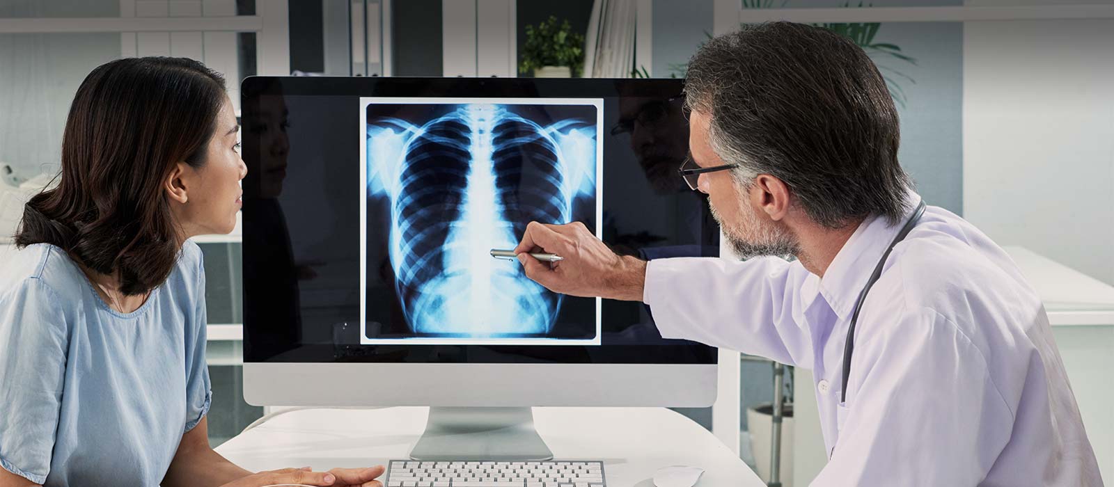 Doctor and patient reviewing x-ray image