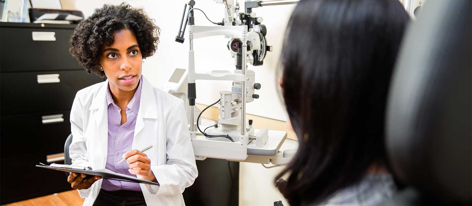 female optometrist and patient