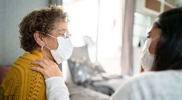 Senior female patient wearing mask in doctor's office