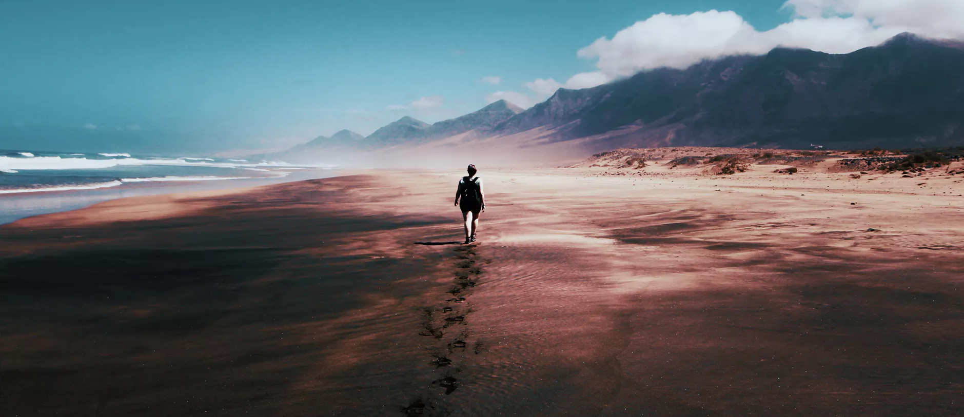 person walking far away on beach