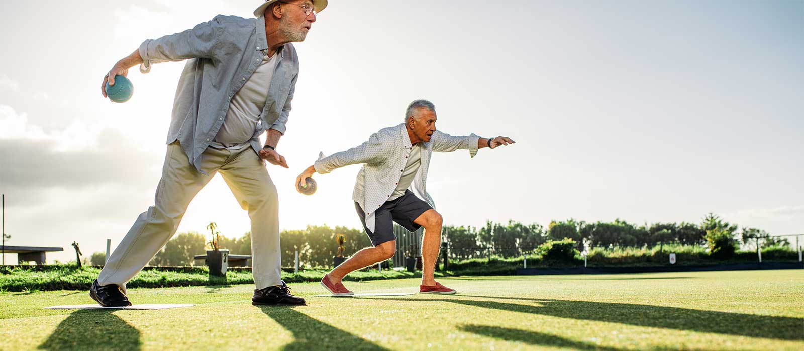 Mature men tossing balls