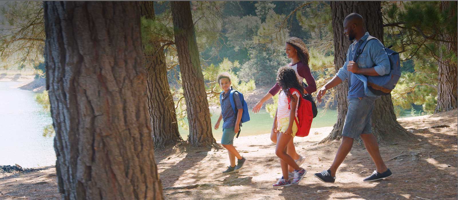 Healthy family hiking by a lake