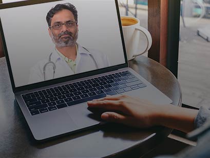 Person having a video visit with a doctor on a laptop screen