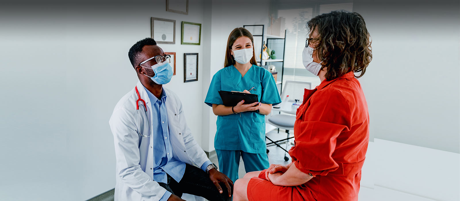 Doctor, nurse and patient in exam room