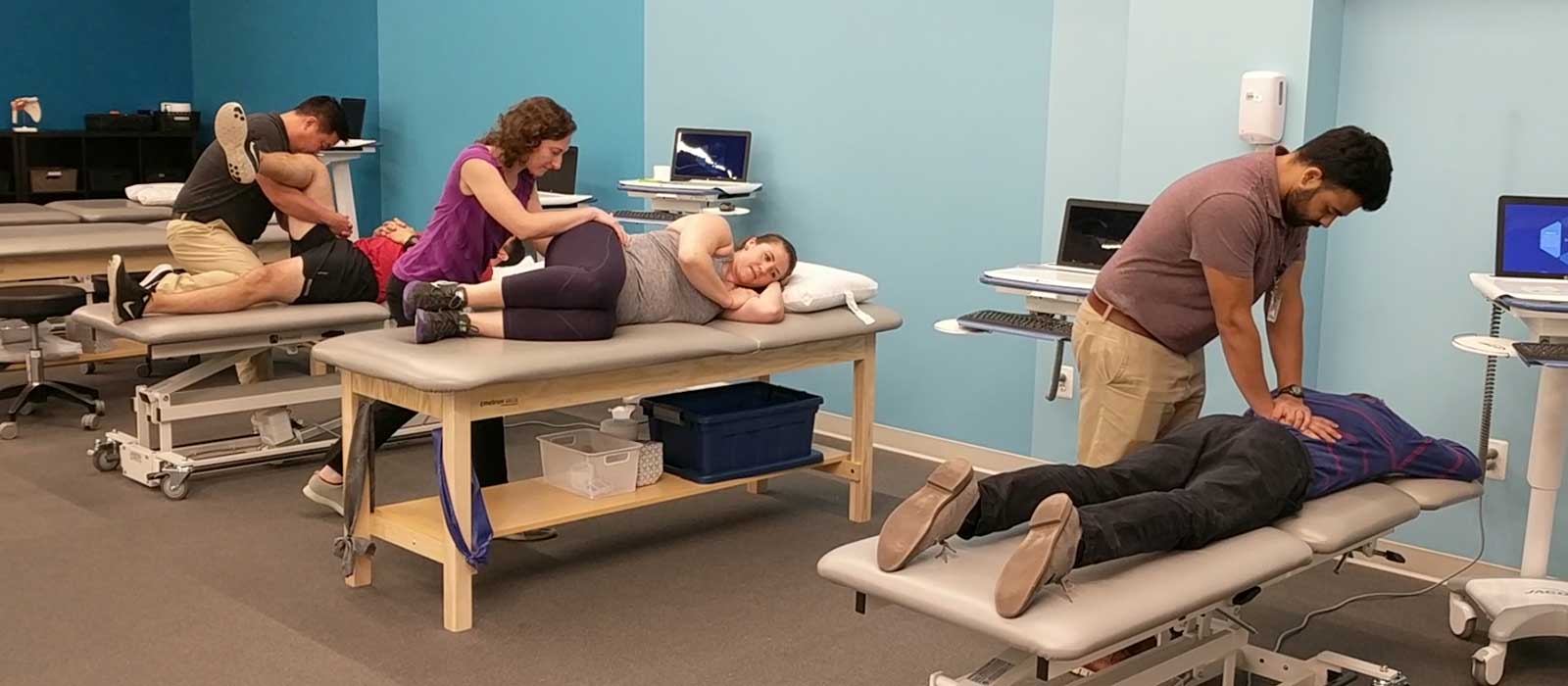 Physical therapists treating clients.