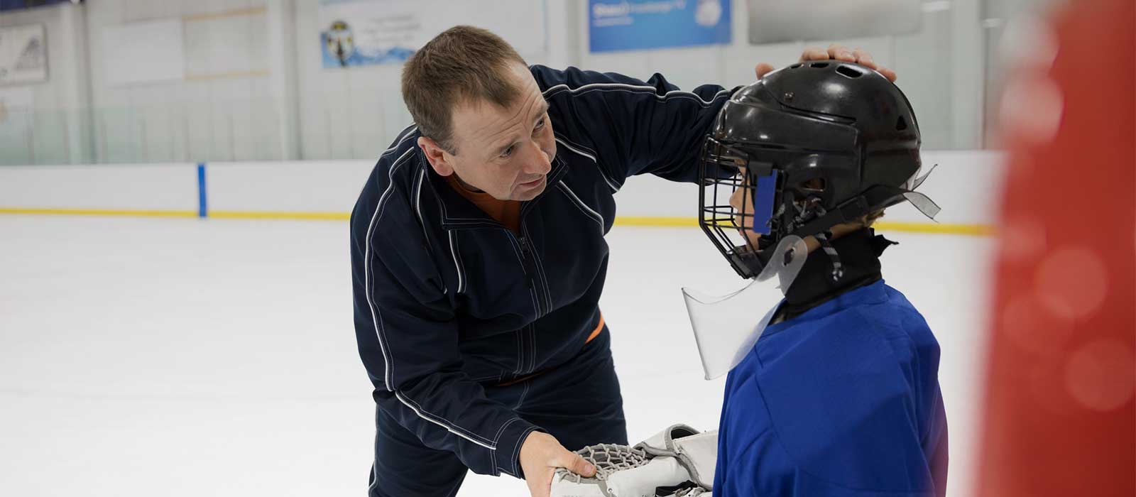 Coach evaluating youth hockey player