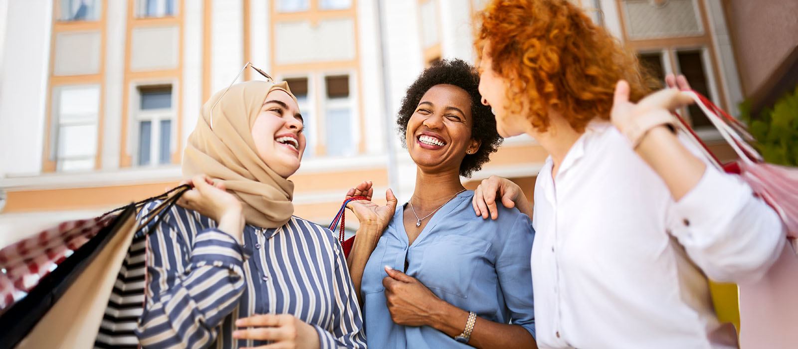3 female friends with shopping bags