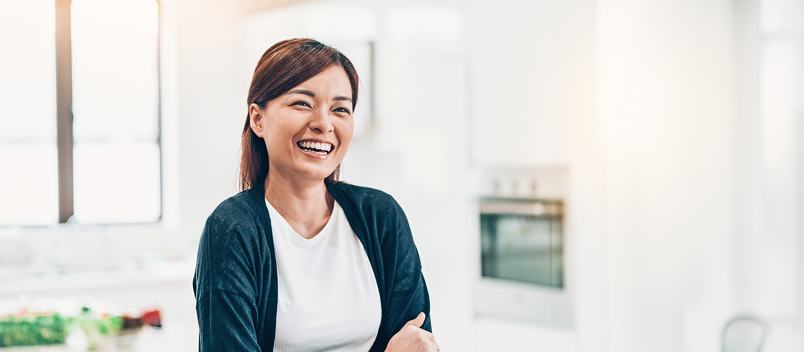 Happy Asian woman at home kitchen