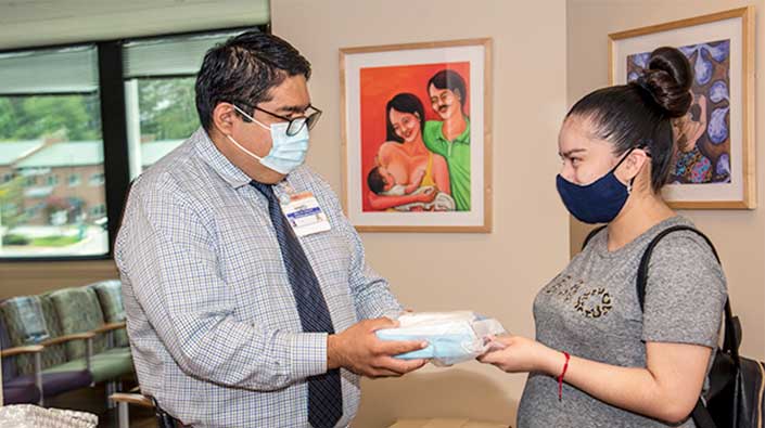 Healthcare worker provide diaper to female patient