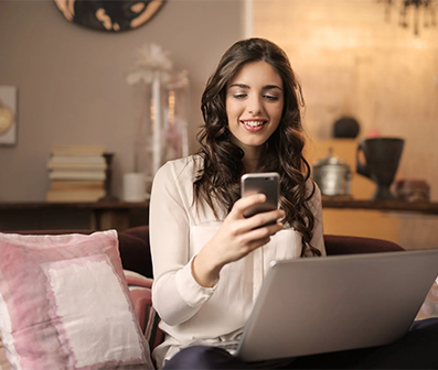 young woman with smartphone and laptop