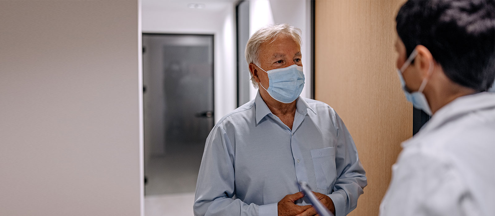 Senior patient greeted by medical resident