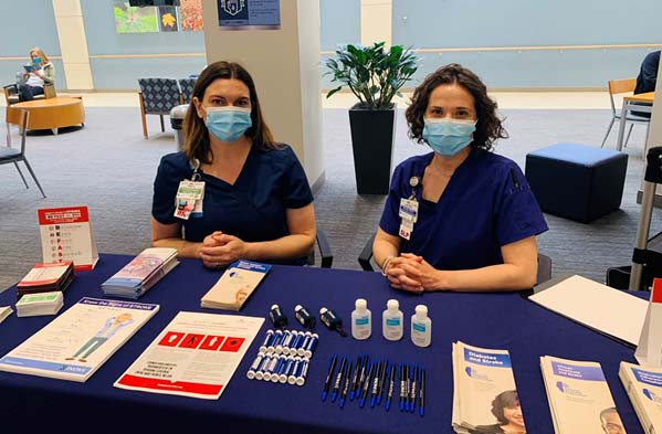 Two people at stroke awareness event table