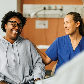 Smiling female patient sitting with her healthcare provider