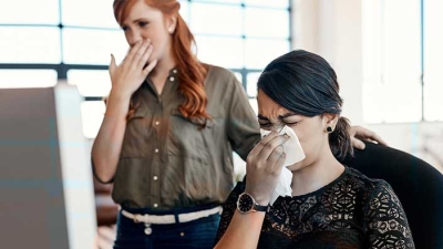 Office worker sneezing 