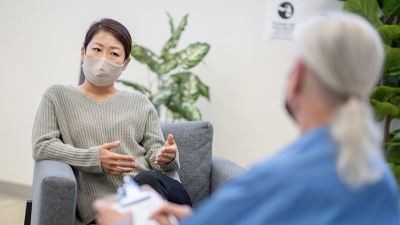 Masked female patient with counselor
