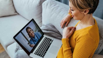 Woman at home video conference on her laptop.