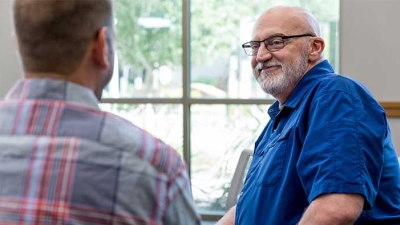 man listening in group therapy session