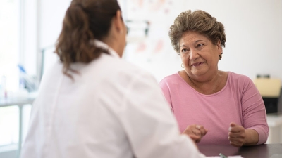 Older woman speaking and consulting with the doctor about her concerns