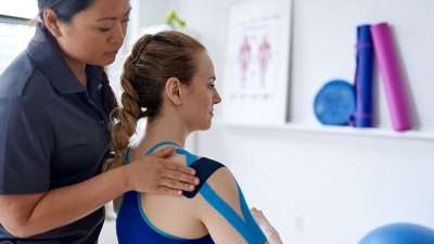Physical Therapist applying compression tape.