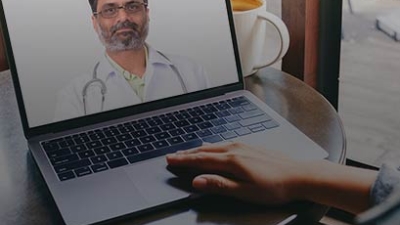 Person having a video visit with a doctor on a laptop screen