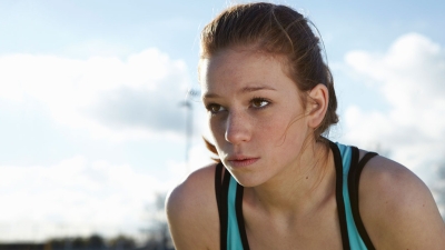 female athlete crouched and looking into the distance
