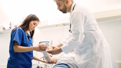 doctor and nurse wrapping a wound