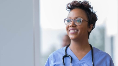 Youthful nurse looking up optimistically